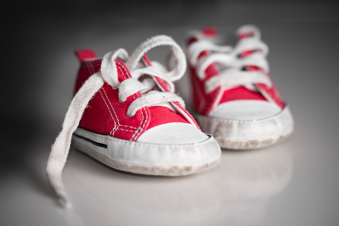 Red canvas baby sneakers with white laces